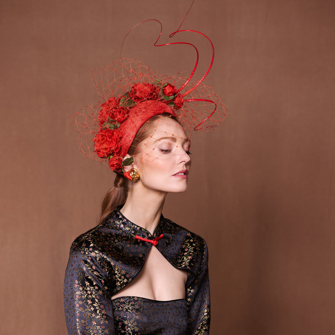 Burnt orange crescent with handmade roses, quills and veiling