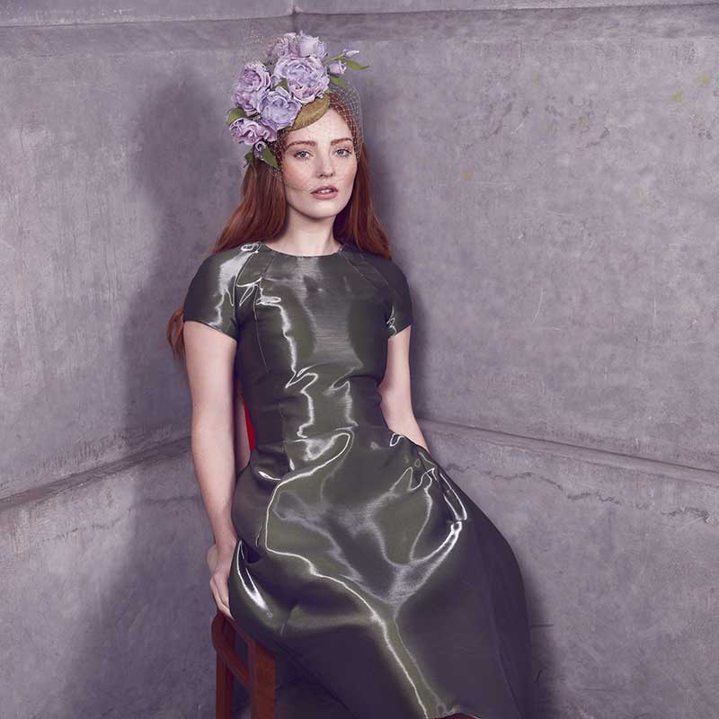 Green mini pillbox with lilac toned roses and veil