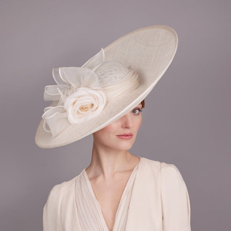 Woman with sparkly fine straw sidesweep with an organza camellia