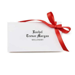 White envelope with red ribbon saying Rachel Trevor-Morgan Millinery