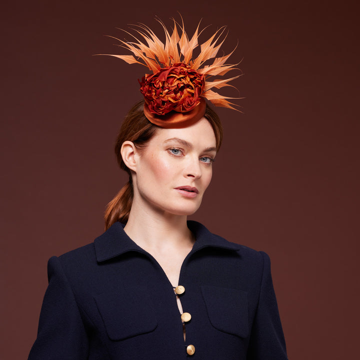 Rust satin pillbox with diamond-cut feathers and flowers