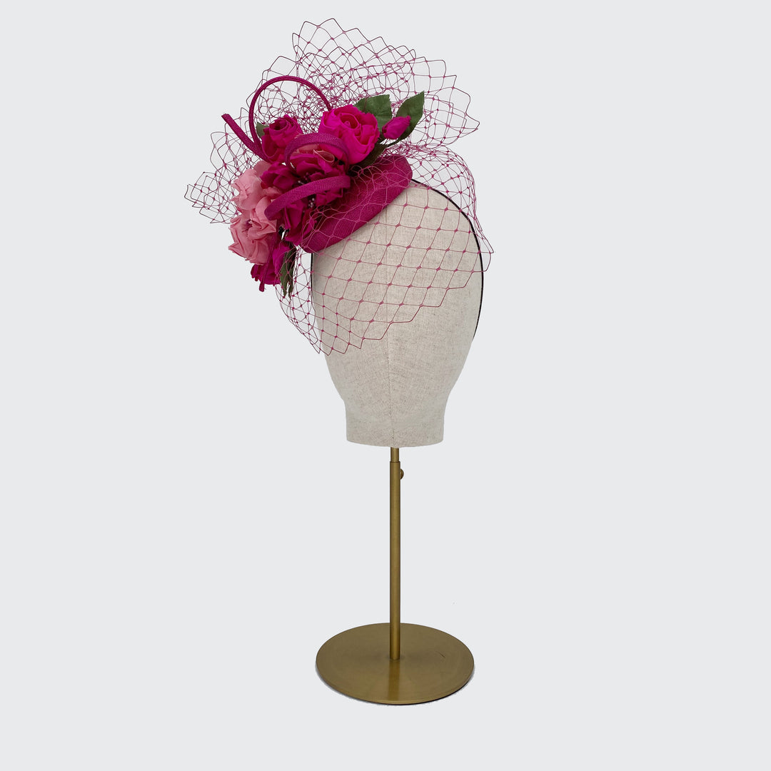 Deep pink mini pillbox with roses and veil