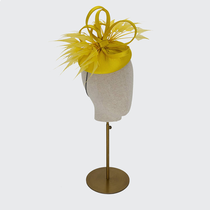 Yellow silk pillbox with diamond-cut feathers and loops