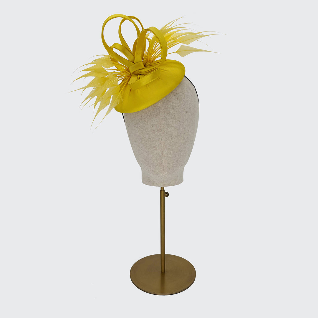 Yellow silk pillbox with diamond-cut feathers and loops