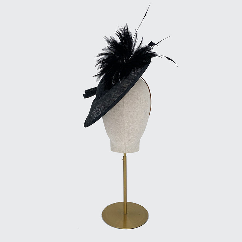 Black disc with feather spray and bow