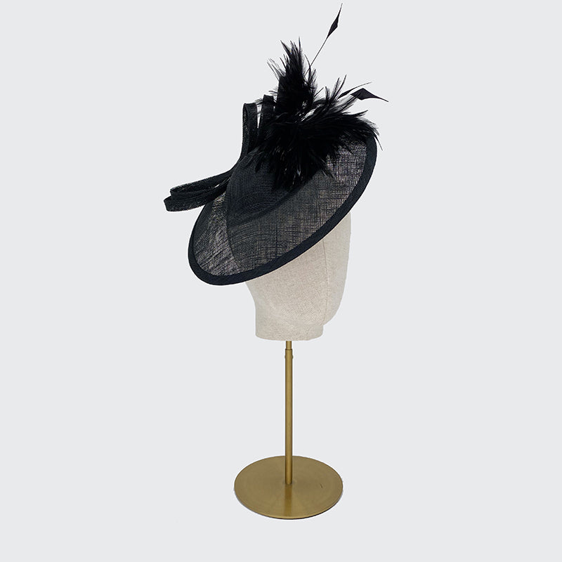Black disc with feather spray and bow