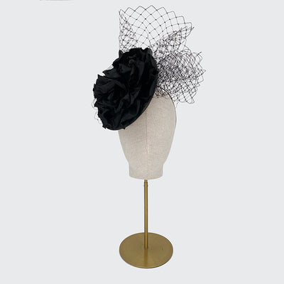 Black disc with large silk flower and veiling
