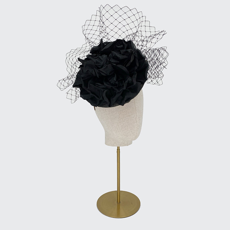 Black disc with large silk flower and veiling