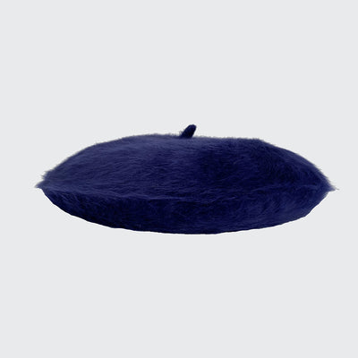 Side view of a dark blue angora beret
