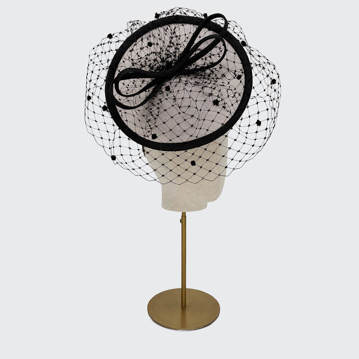 Grey and black disc with spot veiling and bow