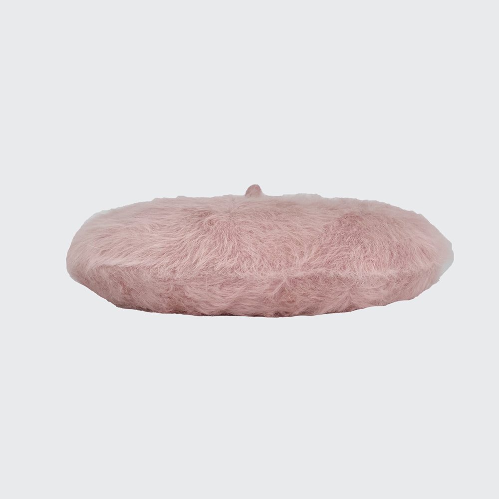 Side view of a pale pink angora beret