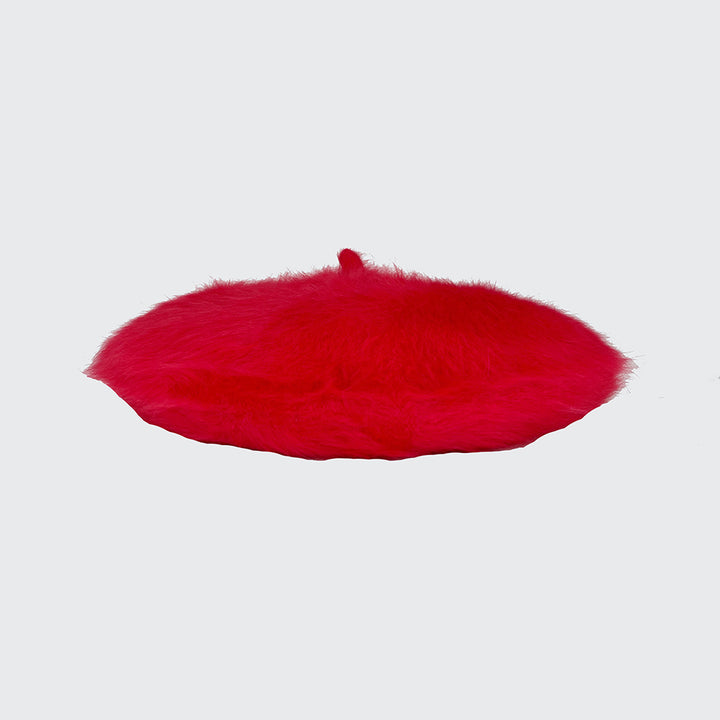 Side view of a poppy red angora beret
