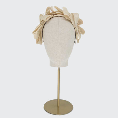 Photo of a natural fine straw bow headband on a linen display head