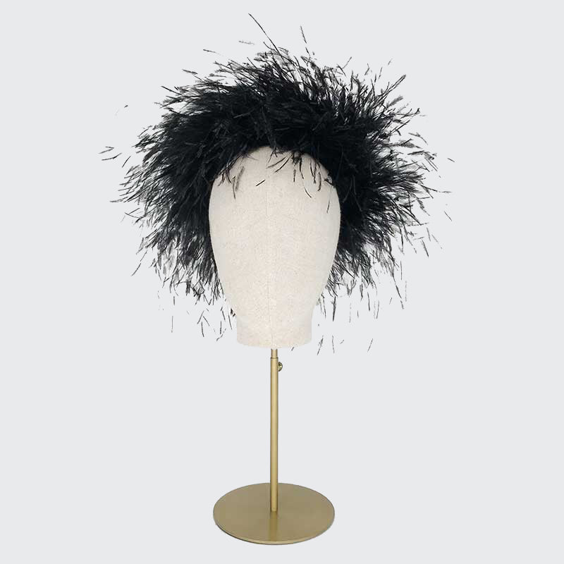 Photo of a black ostrich feather Jackie O pillbox on a linen display head