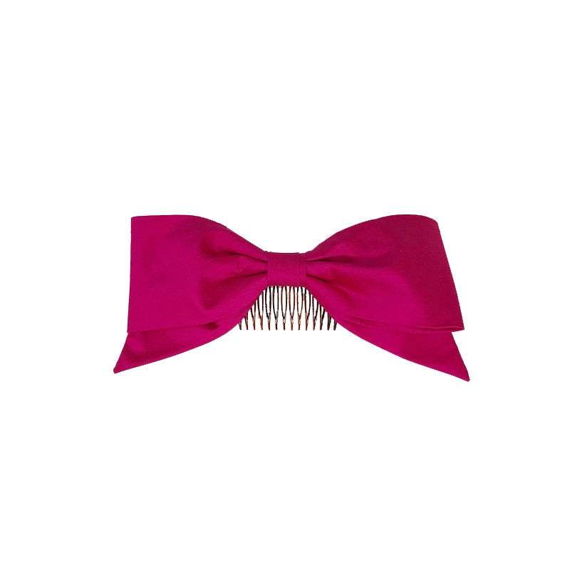 Photo a large pink silk bow clip or comb