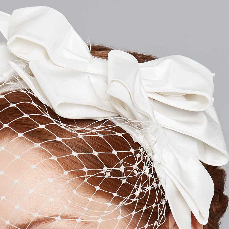 Close up of the ivory bow headband with veil