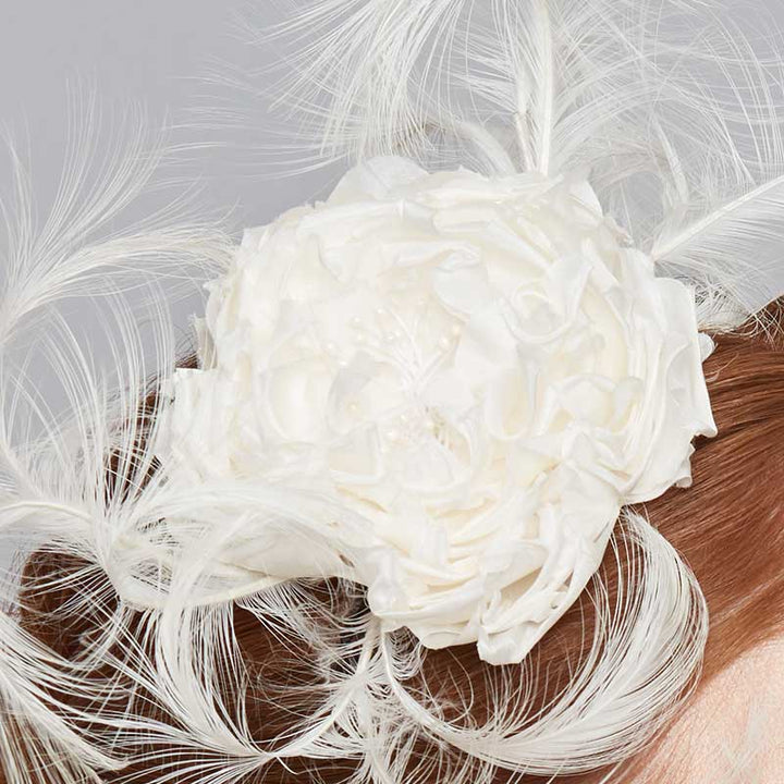 Close up of the ivory silk flower headband with curled feathers