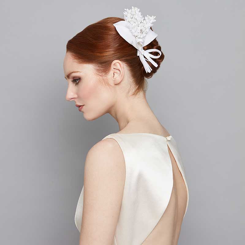 Bride wearing a lily of the valley comb with bow