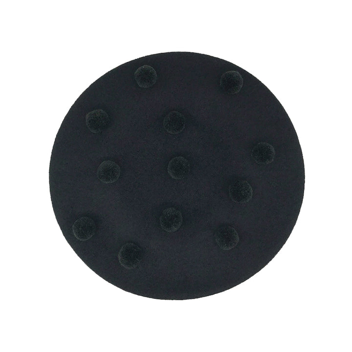 Photo of a black wool beret with black pom poms 