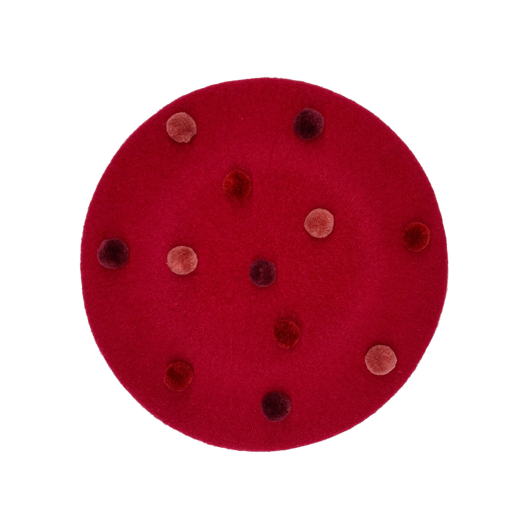 Photo of a deep red wool beret with red pom poms 