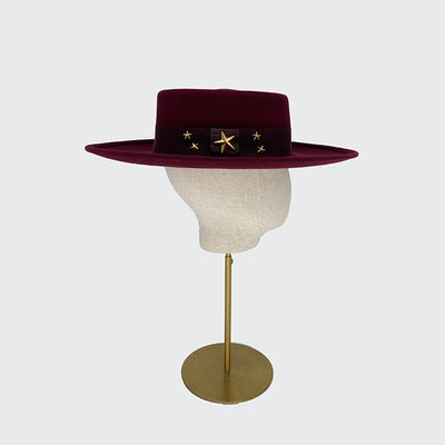 Side view of a burgundy wool fedora and gold stars