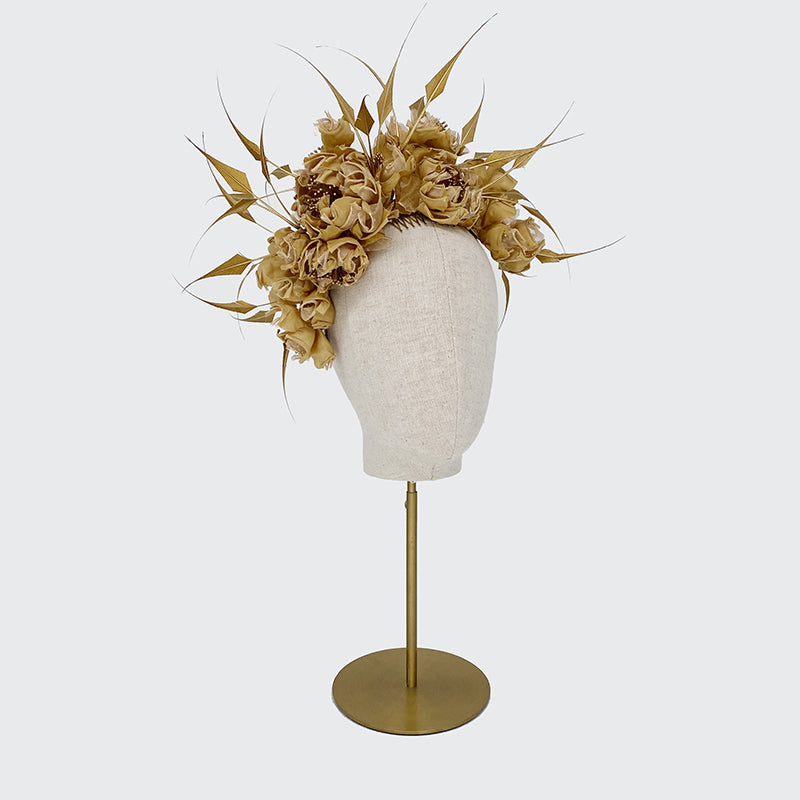 Side view of a brass gold silk headdress with diamond-cut feathers