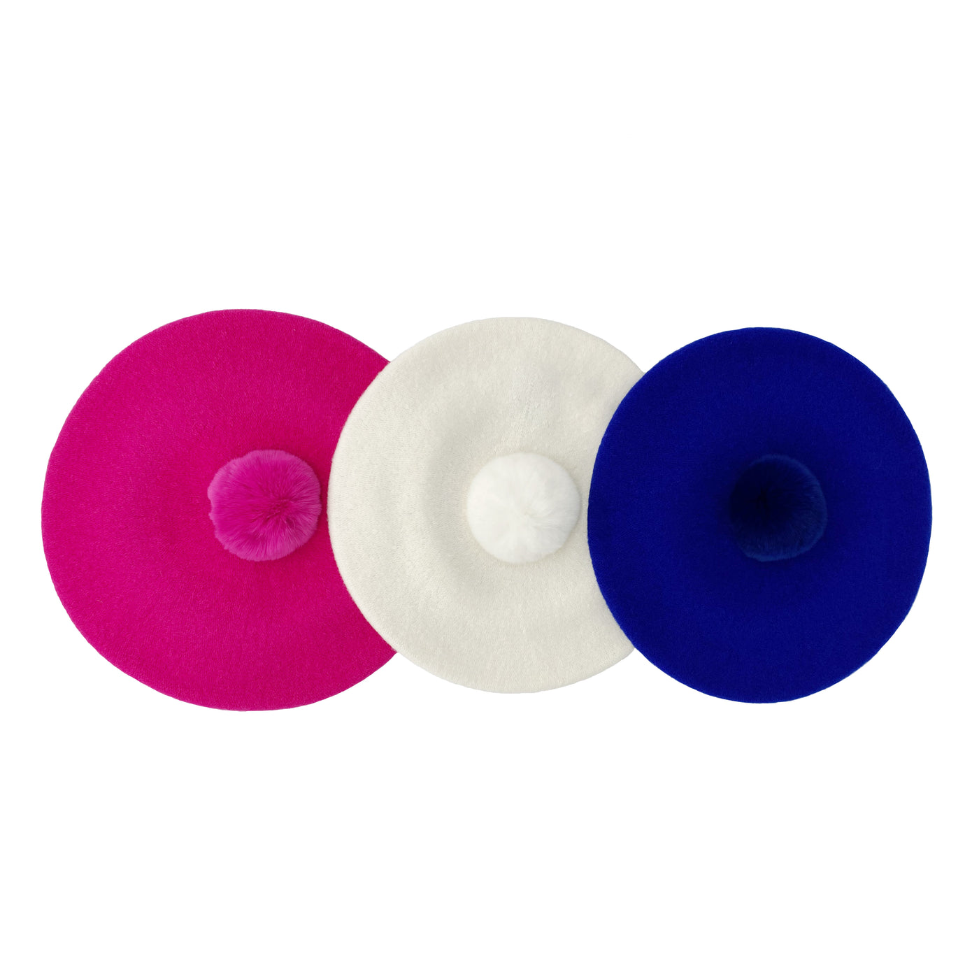 Photo of three berets with fur poms in royal blue, hot pink and white