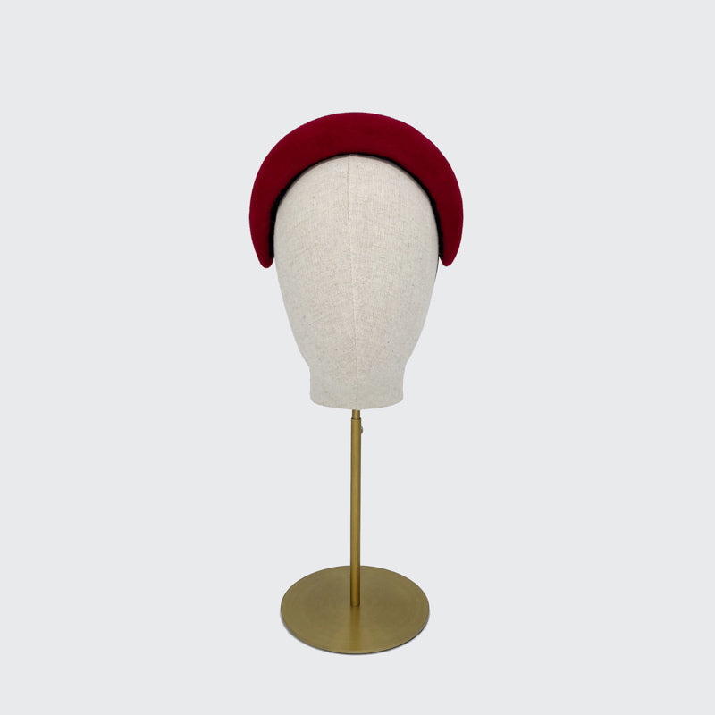 Photo of a red velour felt wide headband on a linen display head