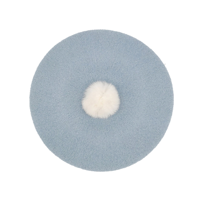Photo of pale blue wool beret with white fur pom