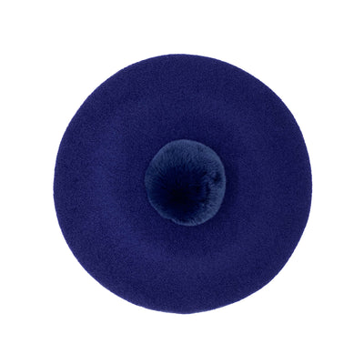 Photo of navy blue wool beret with navy fur pom
