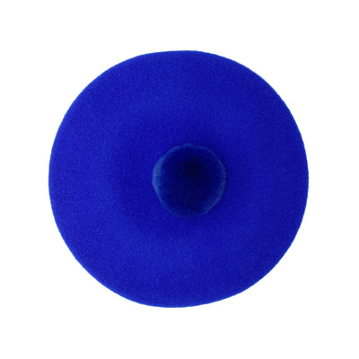Photo of royal blue wool beret with royal blue fur pom