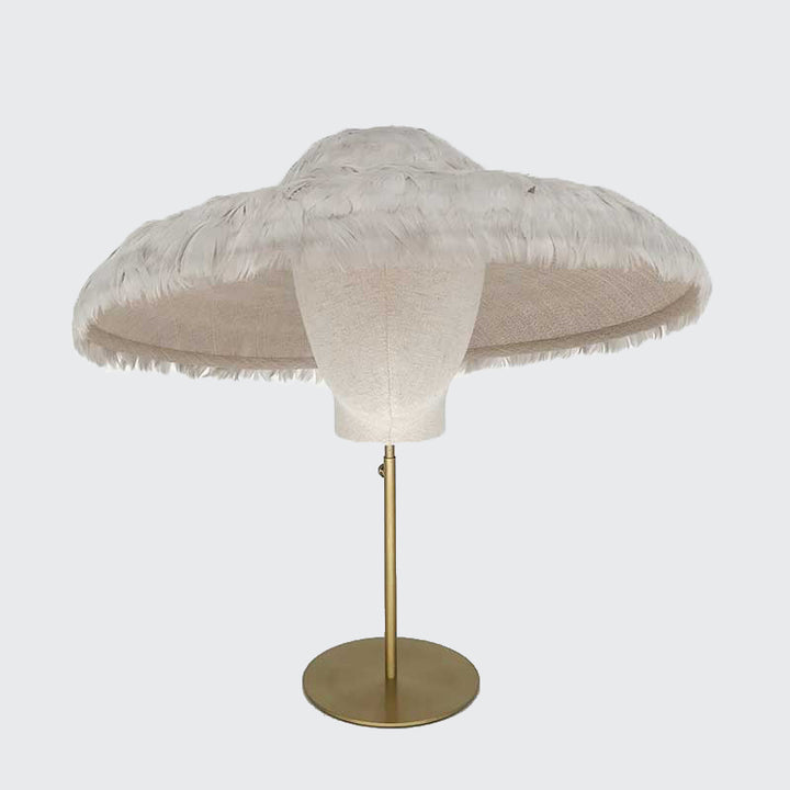 Photo of a grey feathered bell on a linen display head