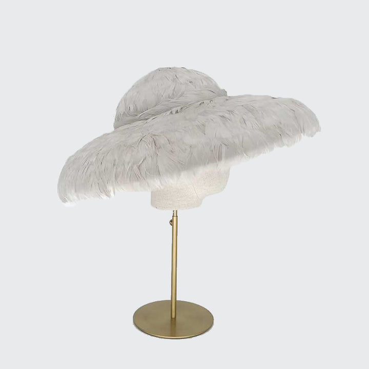Photo of a grey feathered bell on a linen display head