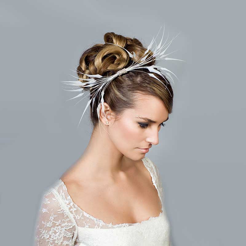 Bride wearing a soft feather headband with diamante