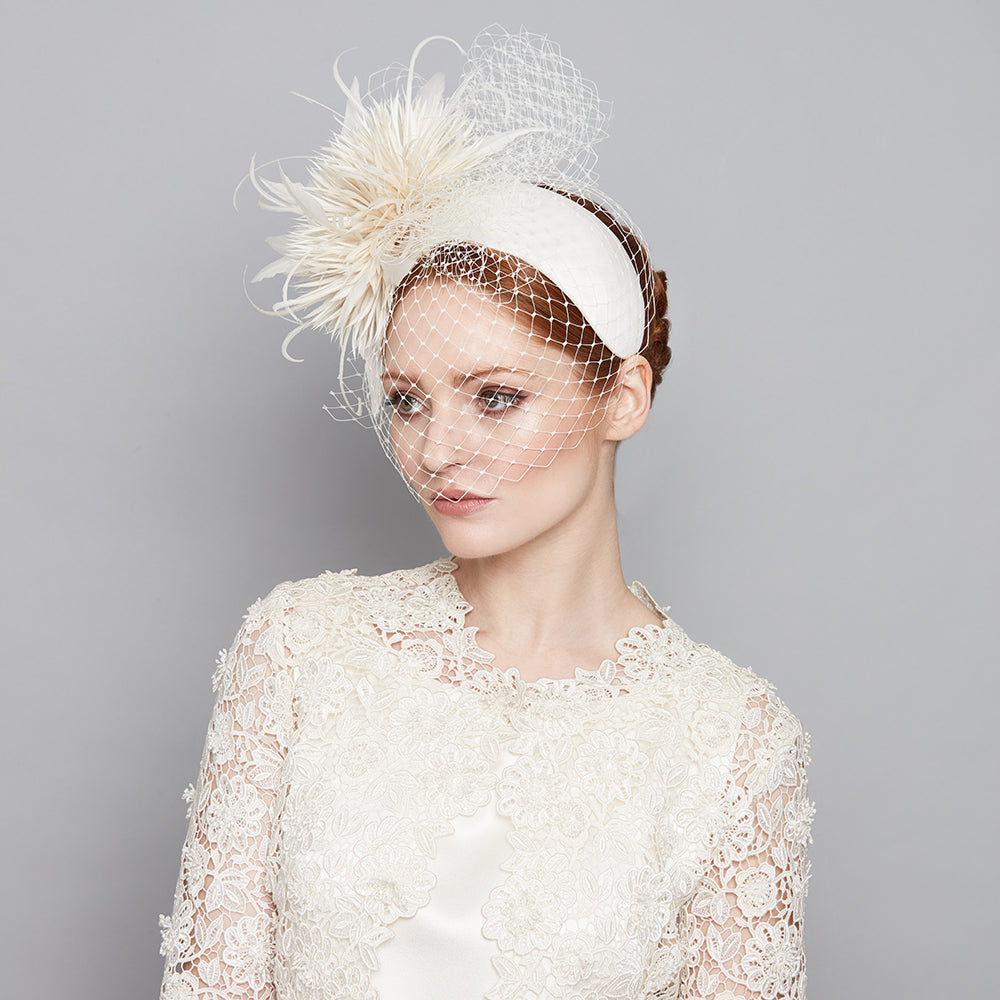 Ivory silk crescent with feather pom and veil