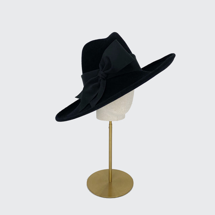 Side view of a black high crown velour felt fedora with wide grosgrain band