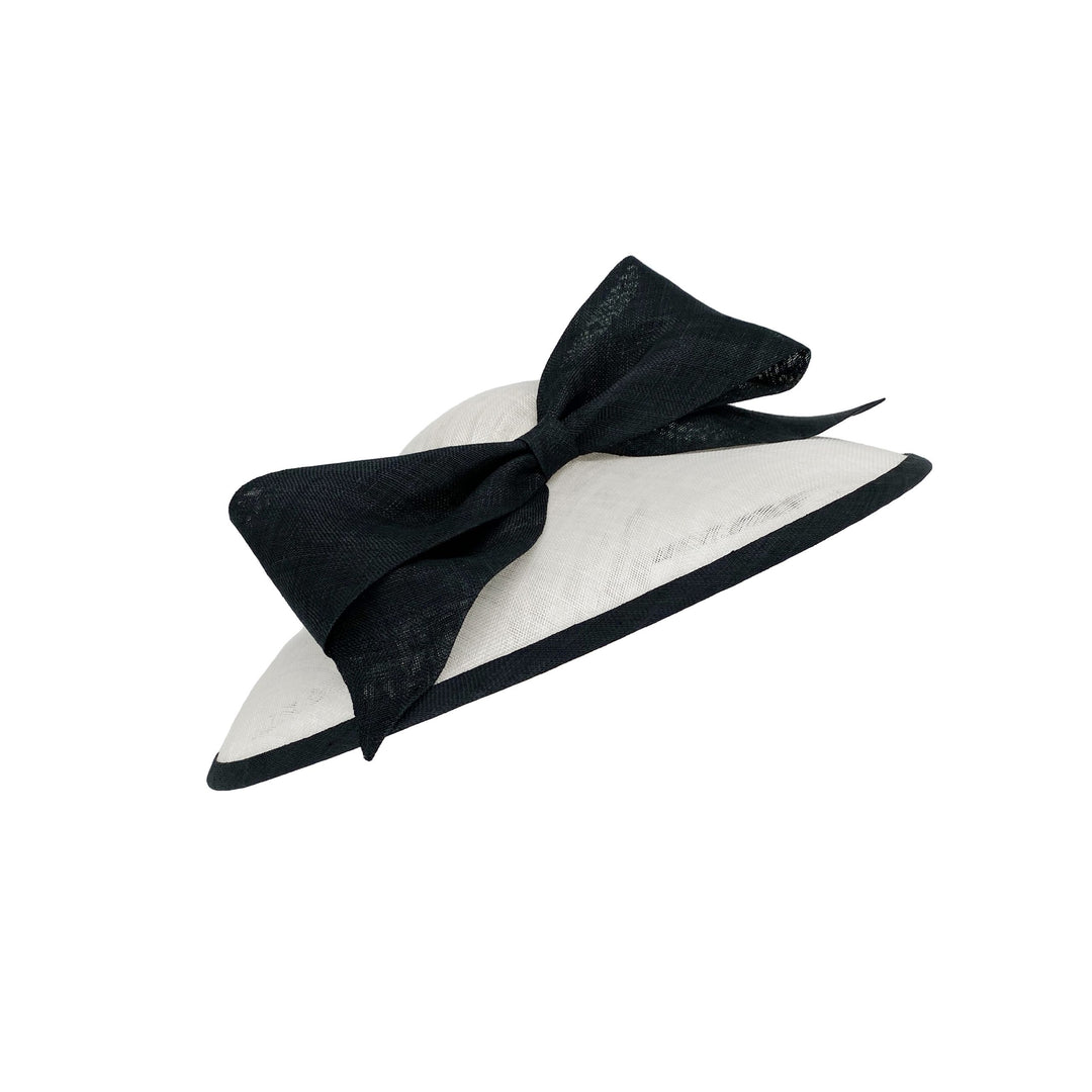 Photo of a white sweep bell with a black edge and a large bow 