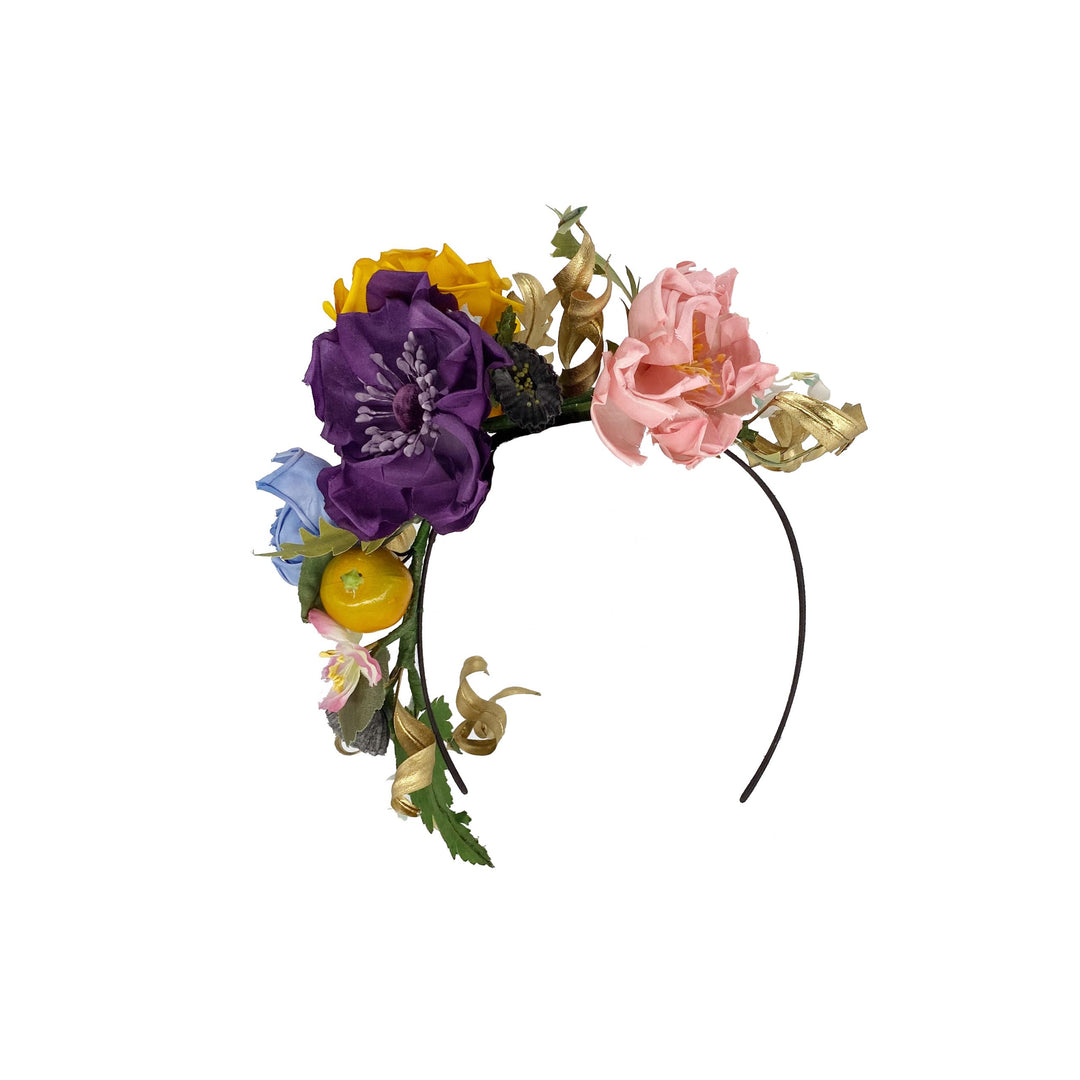 Photo of a silk flower headband with gold leaves, lily of the valley and fruit