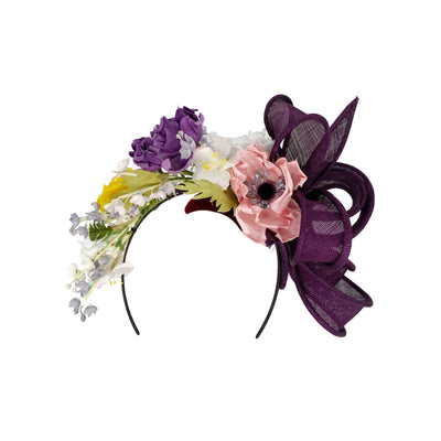 Photo of a purple and silk flower headband with a looped bow on the side
