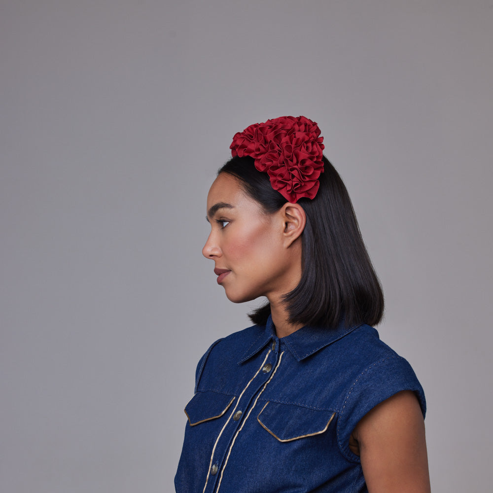Woman with dark hair wearing a denim dress and a red ruched grosgrain wide headband