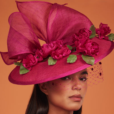 Magenta fine straw disc with roses, bow and face veil